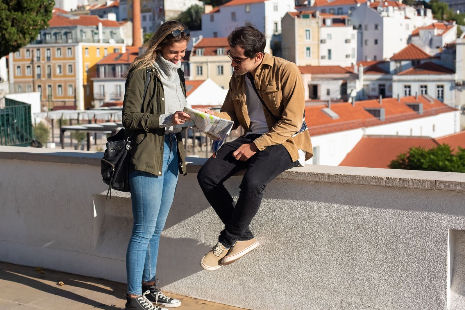 Two travelers reading a map above a European old town, checking whether it is safe to take a river cruise in Europe