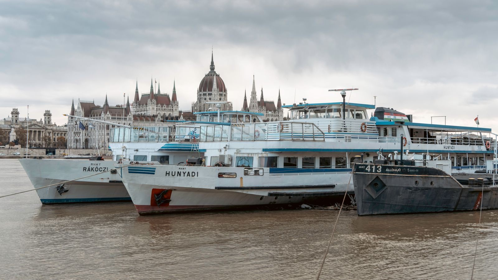 River cruise ships moored on the Danube below the Parliament in Budapest, on one of the safest river cruises in Europe